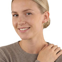AMOR women's hoop earrings, 375 gold, worn by model