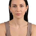 AMOR women's hoop earrings, stainless steel, worn by model